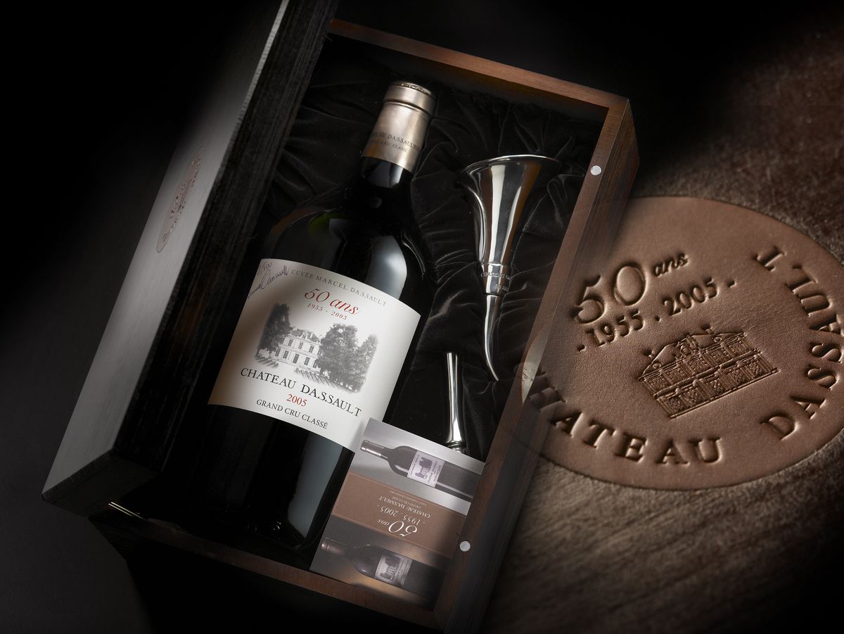 Weinflasche von Chateau Dassault liegend in einer Weinkiste